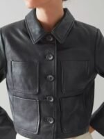“Women’s cropped black leather jacket with button-up front and utility pockets”